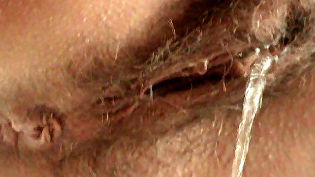 Babe with a hairy puss is pissing so sexy