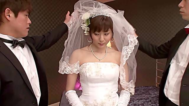 A Japanese bride wears her wedding gown while bouncing on a dick
