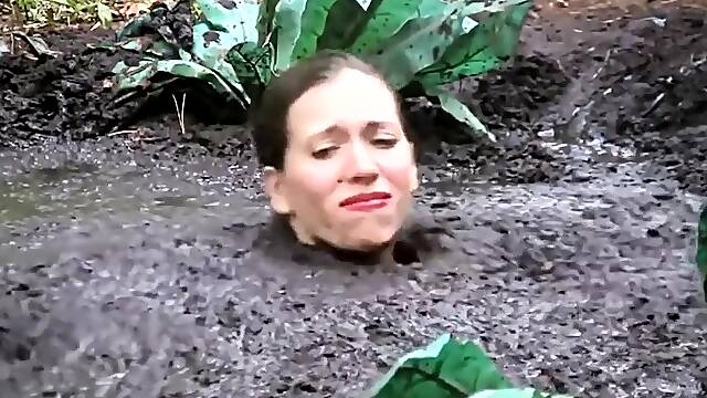 Busty Samantha gets very dirty outdoors in pool of mud