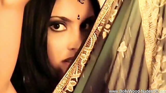 Olive sari with a gold border frames her eyes