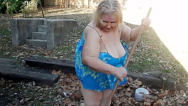 This exhibitionistic granny knows the best way to remove leaves in her yard