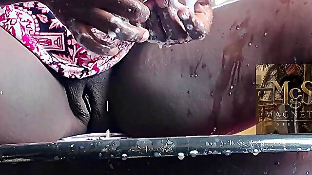 Shaved MILF flaunts gapless pussy on cam while doing laundry
