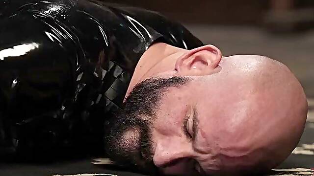 Mistress of latex punishes latex boy