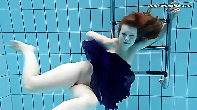 Redhead teen goes swimming in her prom dress