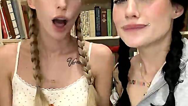 Tattooed Babes with Pigtails Tease in Library