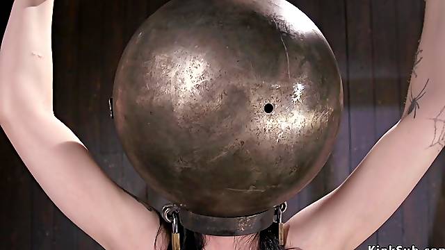 Bald Pussy bitch with hands and head in metal balls