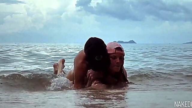 Sexy & risky sex in the sea waves on the beach