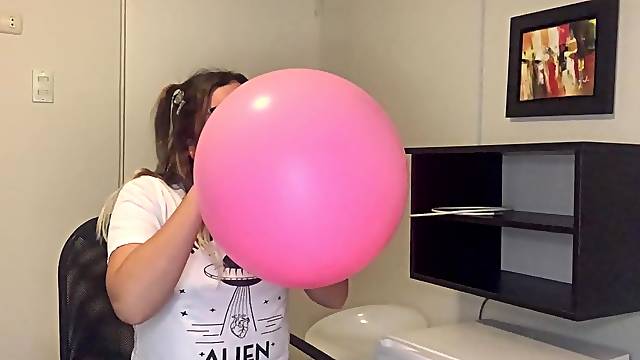 Cute pink balloon popped by blowing hard in it
