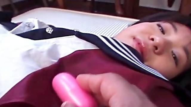 Vibrator arouses her little Japanese titties