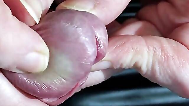 Glans and Peehole Domination with Urethral Penetration in Close up. Main View.