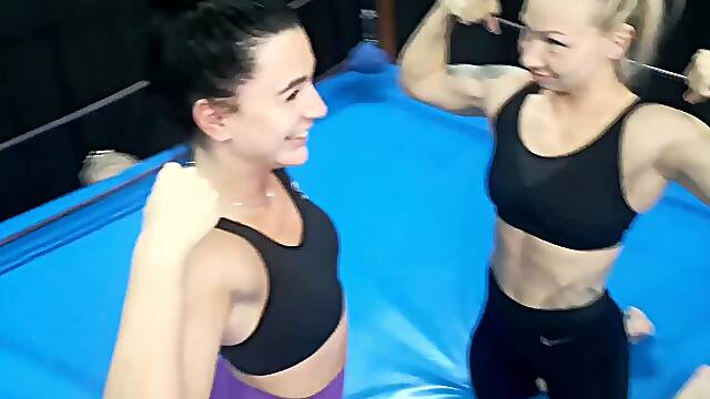 Two female fitness trainers wrestle blondie vs brunette