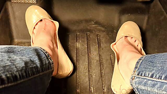 Fifi pedal pumping in sedan wearing shiny nude ballet flats and blue jeans