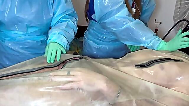 DOUBLE NURSES edge their rubber gimp wearing FULL PLASTIC PPE and minty coloured TIGHT latex gloves