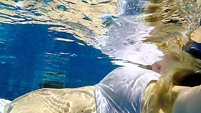 Hot MILF in wet shirt underwater hotel pool