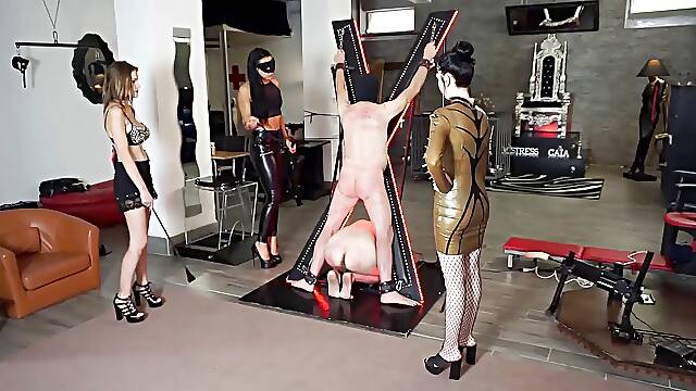 Three femdom chicks whipping and punishing their slaves