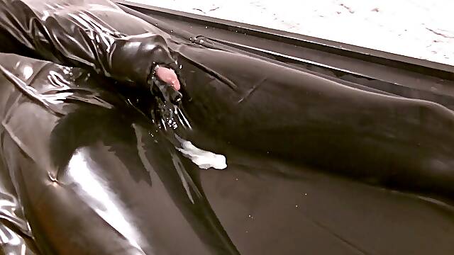 Handjob in the latex vacuum bed by the mistress